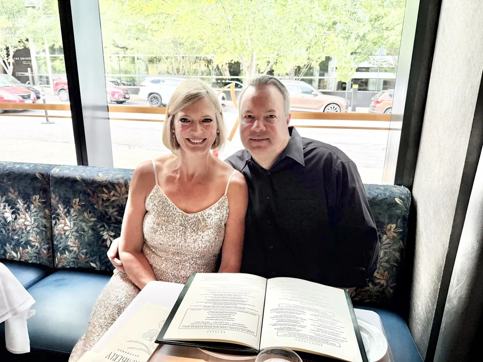 Mark and Jen seated together during Jen’s birthday dinner at The Kimberly