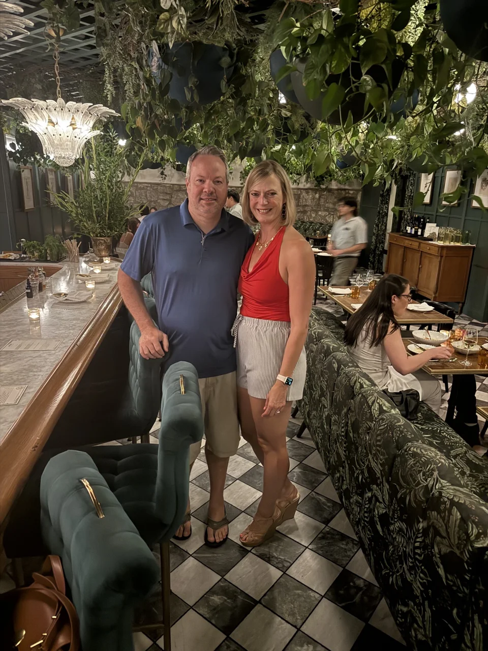 Mark and Jen beside the plant-filled bar at Lutie’s